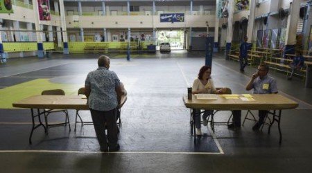 Puerto Rican citizens register before they can exercise their vote during the fifth referendum in San Juan, Puerto Rico, Sunday, June 11, 2017. Puerto Ricans are getting the chance to tell U.S. Congress on Sunday which political status they believe best benefits the U.S. territory as it remains mired in a deep economic crisis that has triggered an exodus of islanders to the U.S mainland. Congress ultimately has to approve the outcome of Sunday's referendum that offers voters three choices: statehood, free association/independence or current territorial status. (AP Photo/Carlos Giusti)