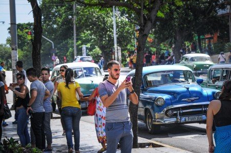 A Cuban man takes a picture with his mobile phone in a street of Havana, on July 2, 2015. Cuban state-owned telecommunications company Etecsa opened 35 public Wi-Fi areas in the country and lowered the rate of connections to half the price in an effort to expand the limited connectivity on the island. AFP PHOTO/YAMIL LAGE (Photo credit should read YAMIL LAGE/AFP/Getty Images)